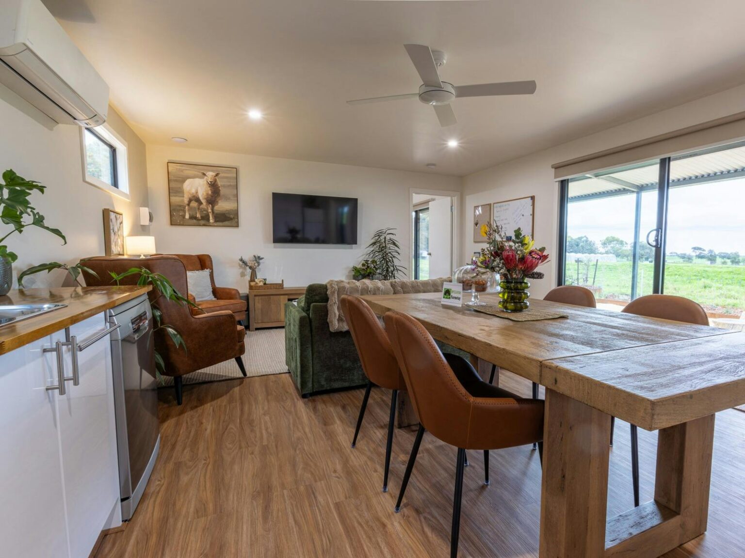 Living area with dining table overlooking paddocks