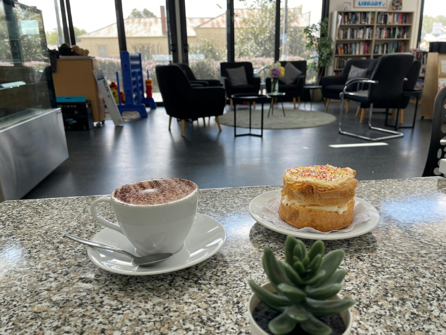 Great Coffee a photo of a cup of coffee and a cake.