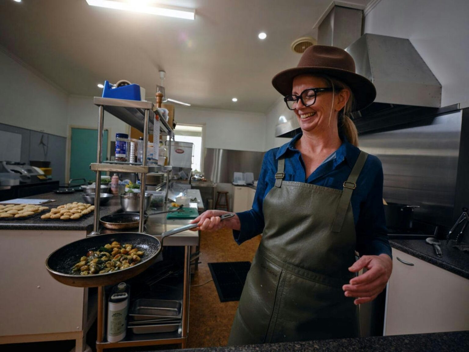 Person cooking a dish in a commercial kitchen