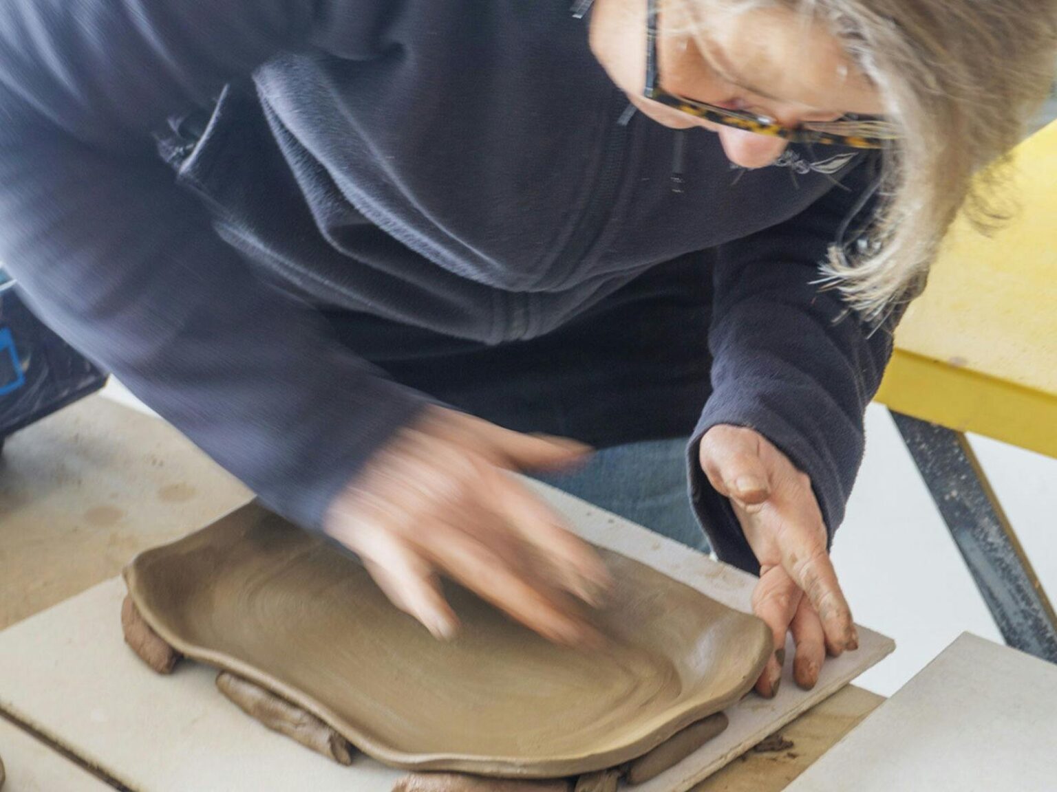 Image of George Khut teaching a student at a pottery wheel
