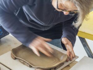 Image of George Khut teaching a student at a pottery wheel