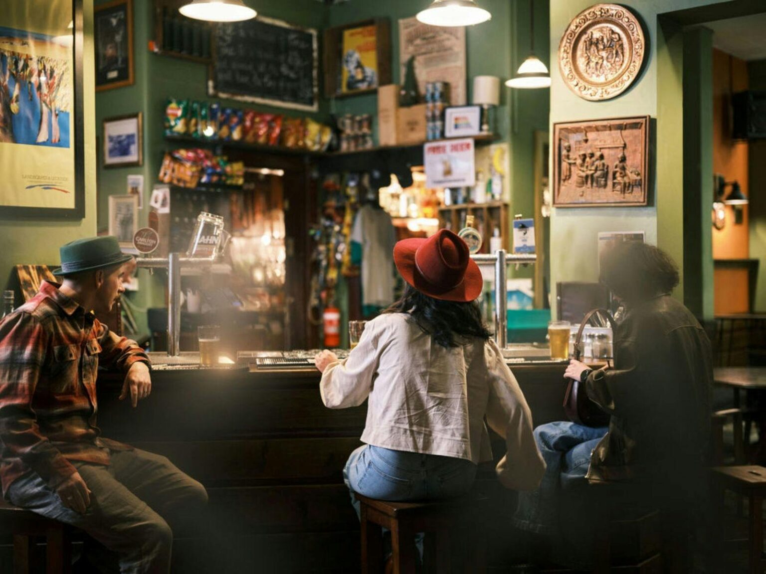 Three people sitting at the bar of a country hotel