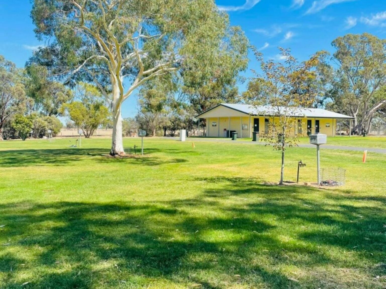 Large open space with an amenities building in the background