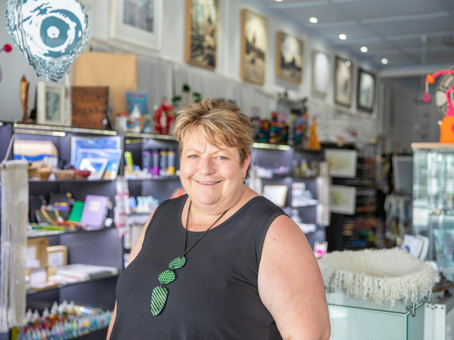 Woman looking at the camera with an art gallery in the background