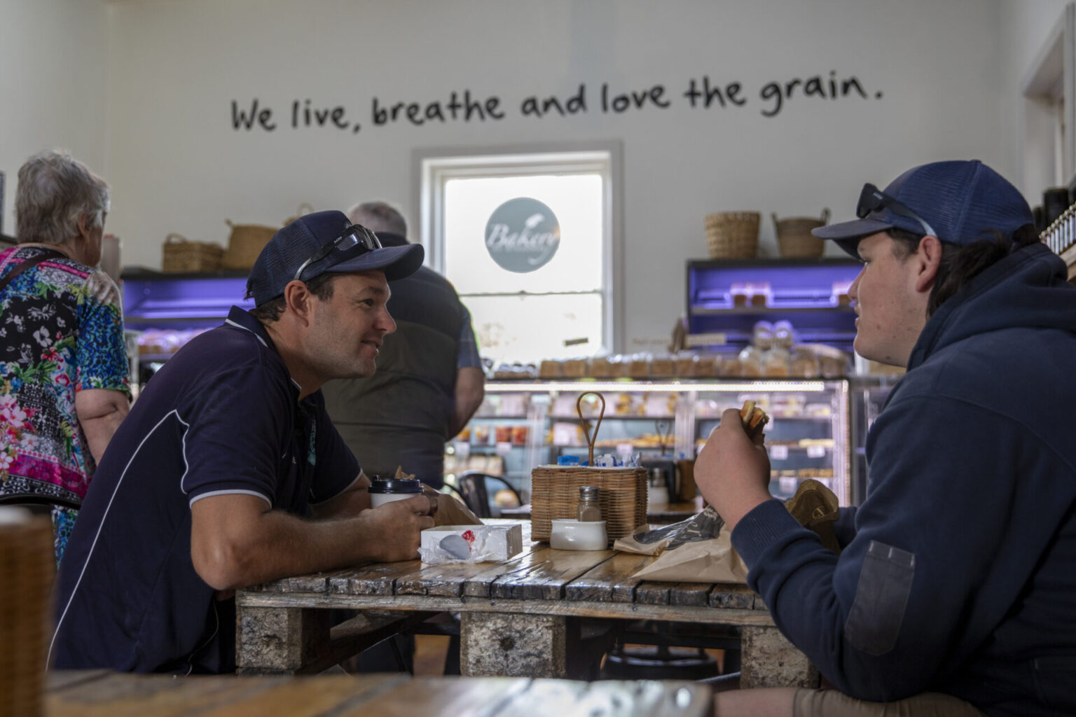 Two people sitting at a table in a country bakery