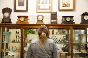 Woman standing in front of a cabinet of curios