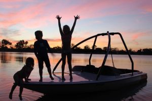 Lake Lascelles children on a boat. lake sunset.