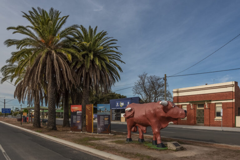 Large red bull sculpture in the main street of a country town