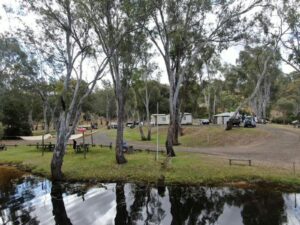 Lake in the foreground with vans