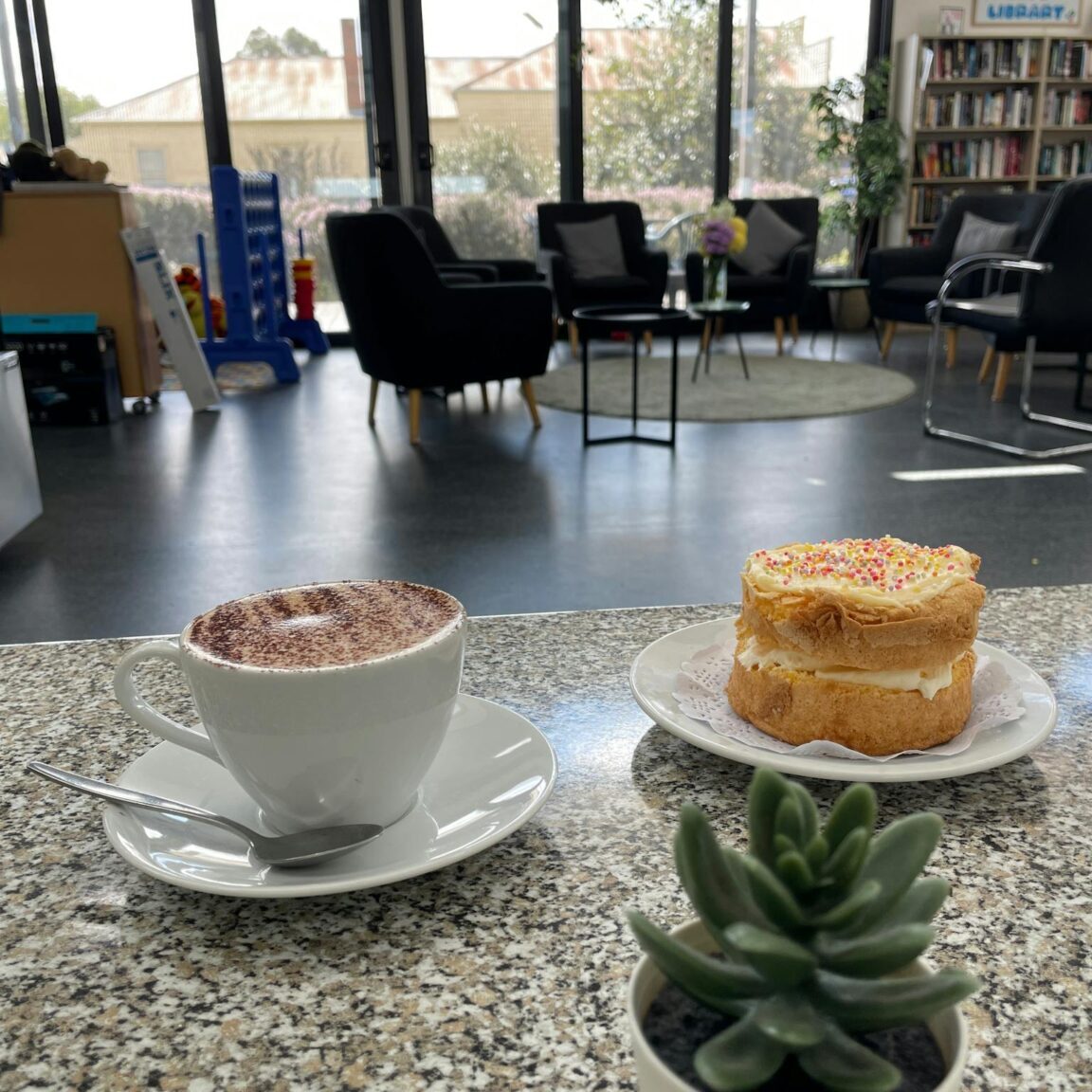 a photo of a cup of coffee and a cake.