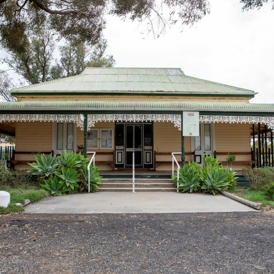 old weatherboard homestead with garden in front of veranda