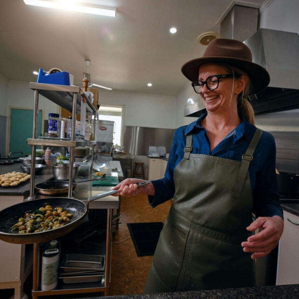 Person cooking a dish in a commercial kitchen