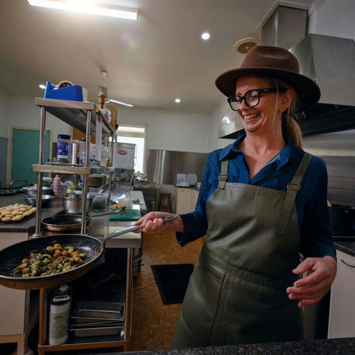 Person cooking a dish in a commercial kitchen