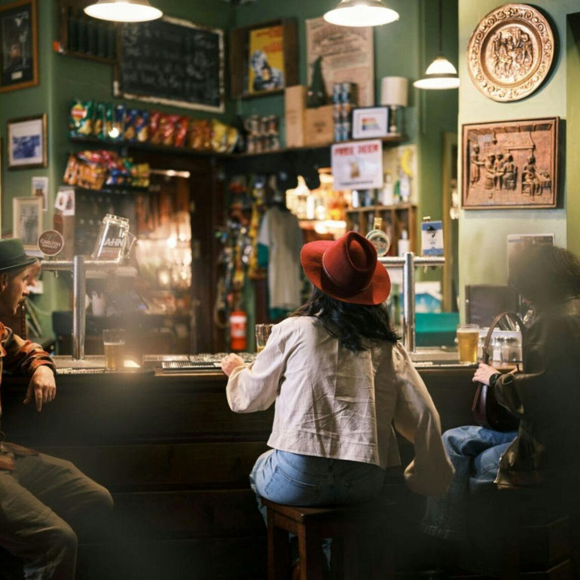Three people sitting at the bar of a country hotel