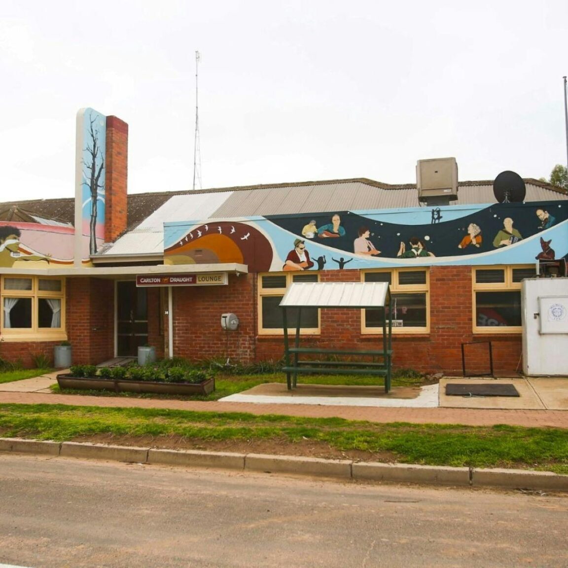 Photo of the exterior of the Patchewollock Hotel with murals