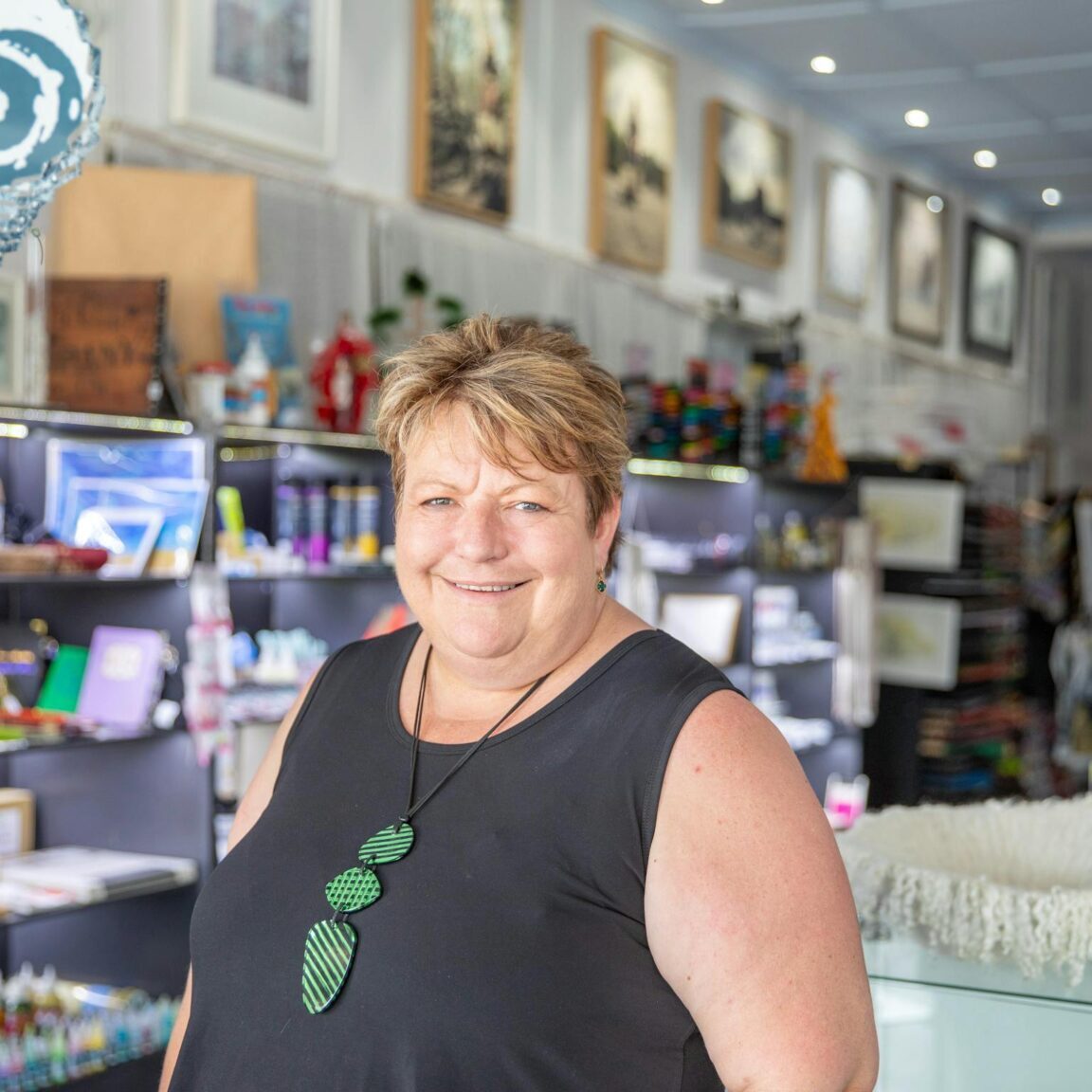 Woman looking at the camera with an art gallery in the background
