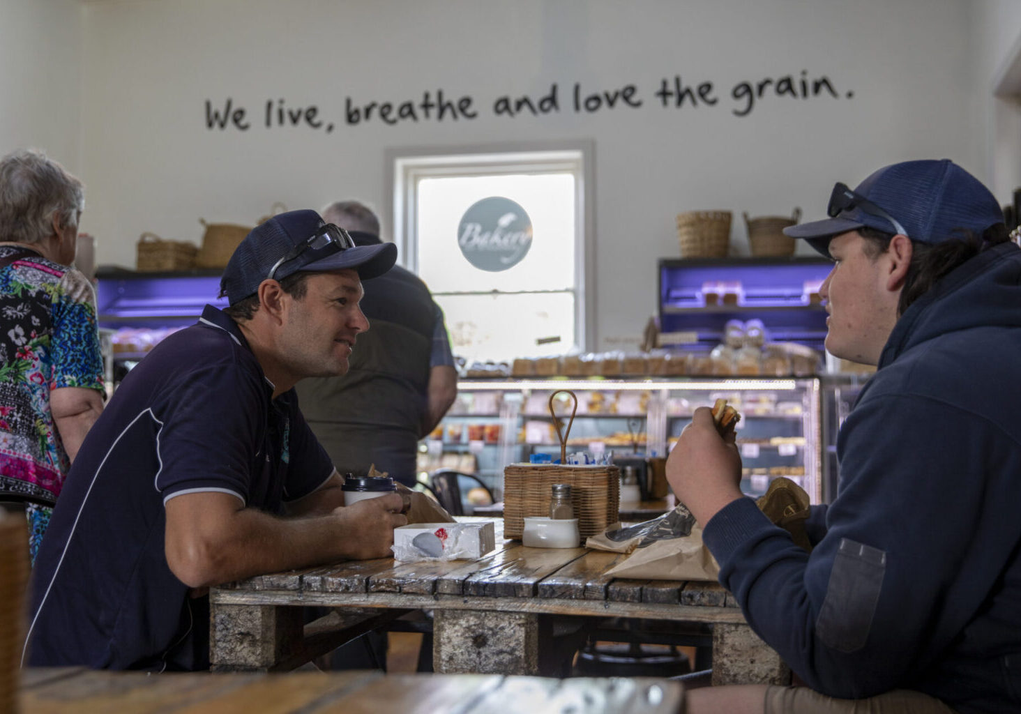 Two people sitting at a table in a country bakery