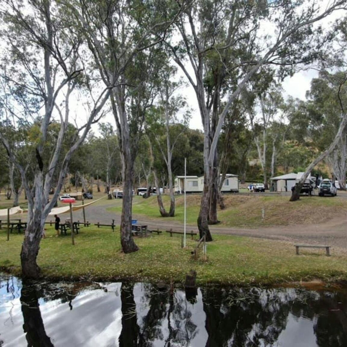 Lake in the foreground with vans
