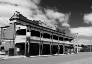 Black and white streetscape with pub on the left