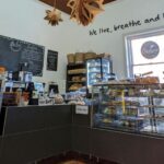 Photo of the interior of a bakery with cabinets of food on display