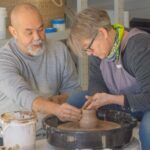 Image of George Khut teaching a student at a pottery wheel