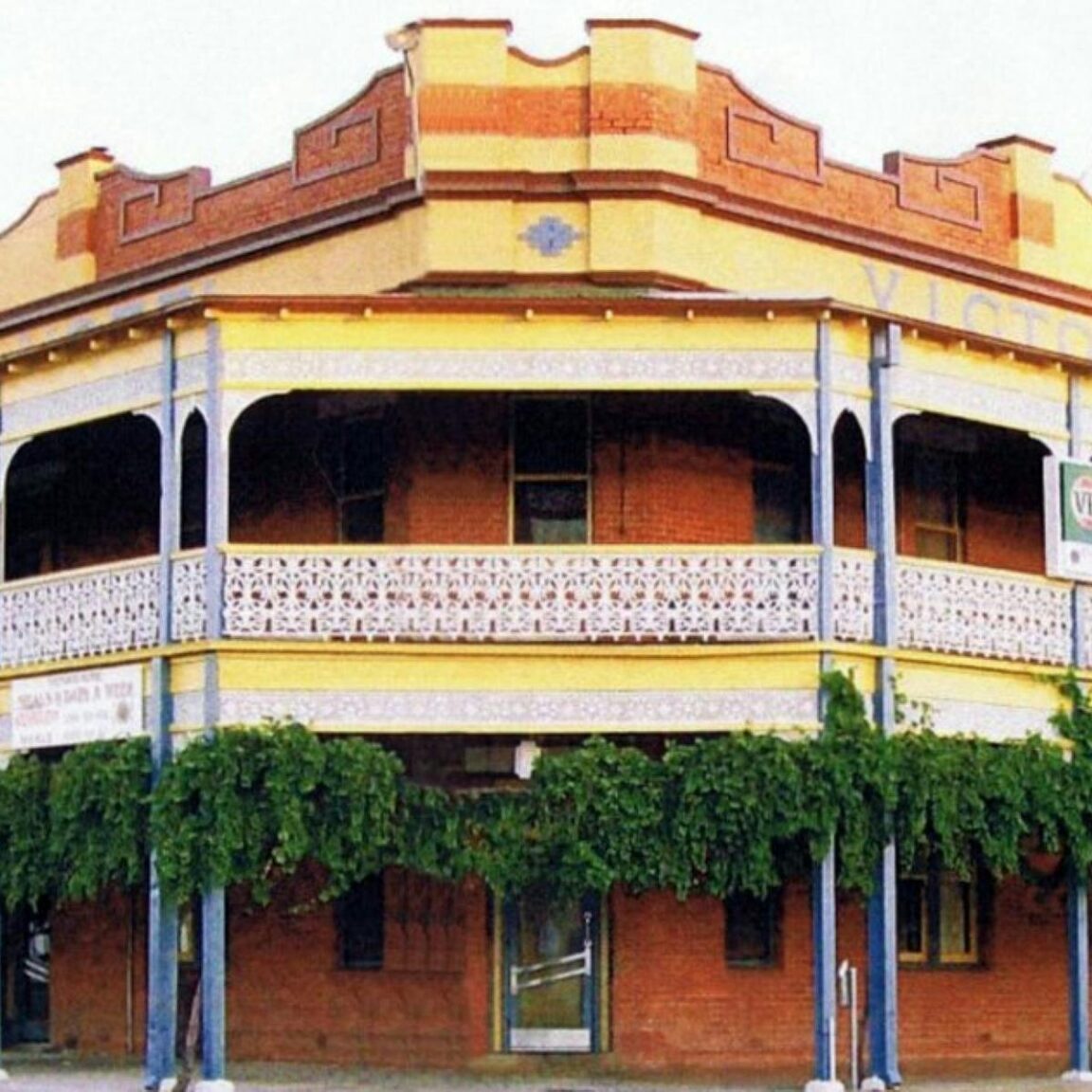 Exterior of a grand old pub with a large wide balcony