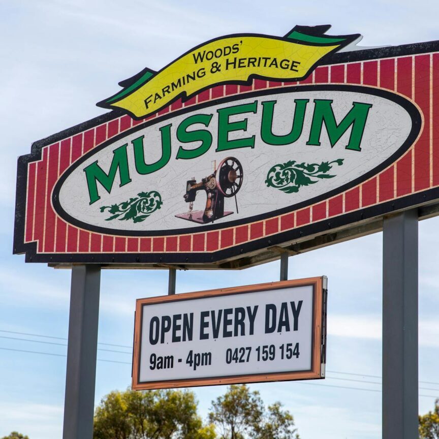 Large sign showing Woods' Museum Open 7 days 9am to 4pm details