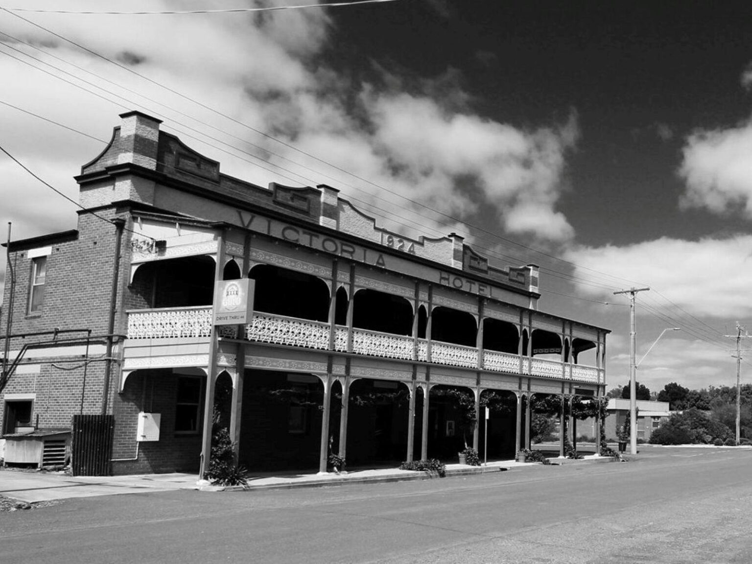 Black and white streetscape with pub on the left
