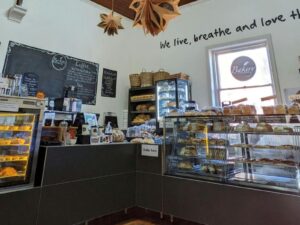 Photo of the interior of a bakery with cabinets of food on display