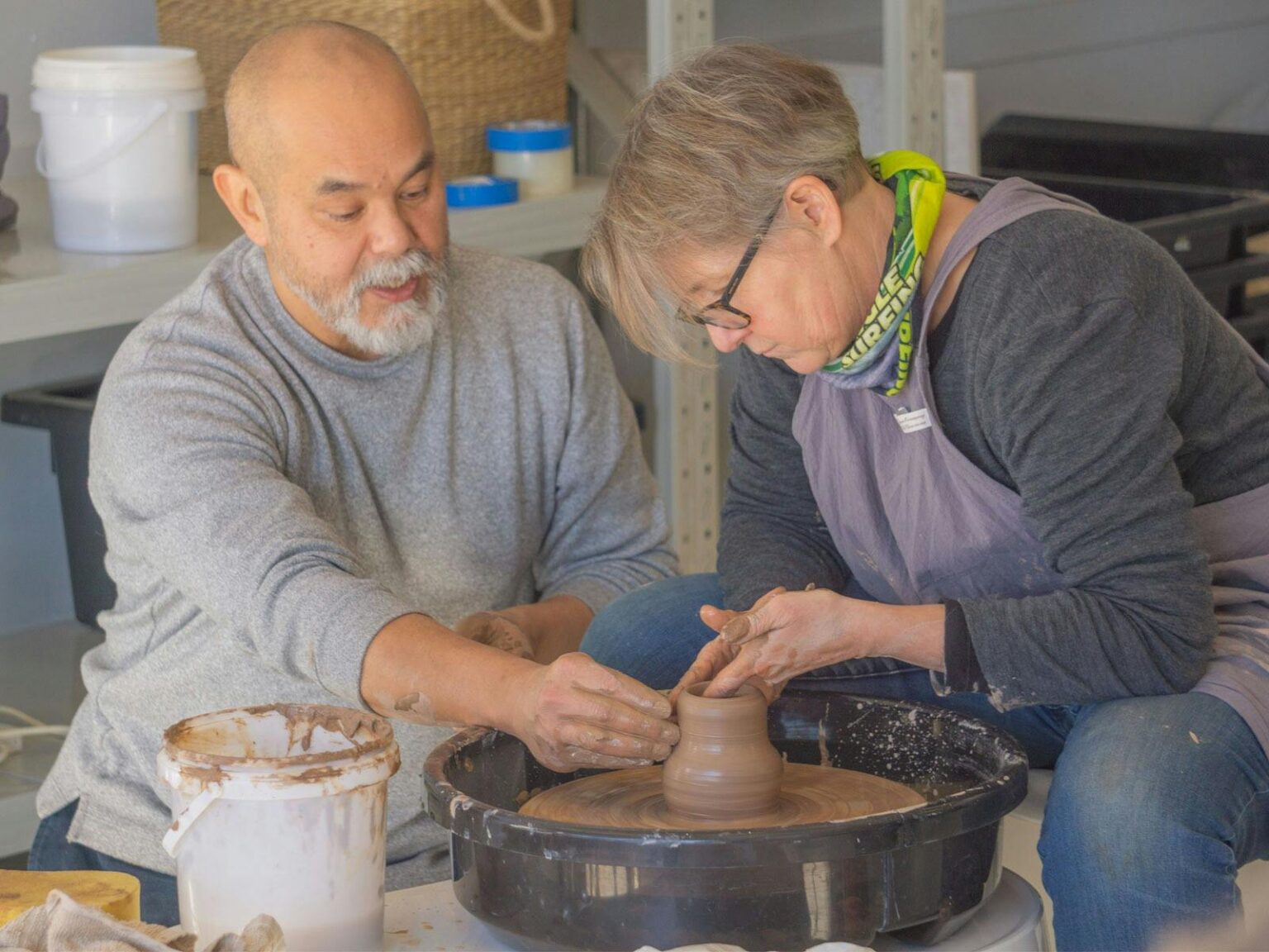 Owner and instructor George Khut leading a pottery wheel class at Dimboola Pottery Image of George Khut teaching a student at a pottery wheel