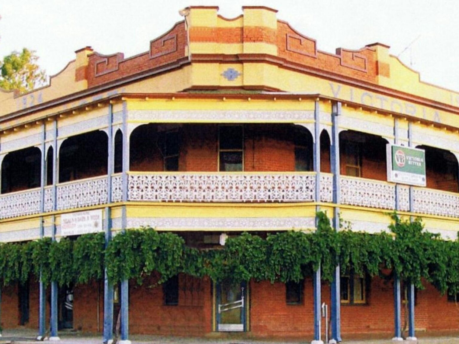 Exterior of a grand old pub with a large wide balcony