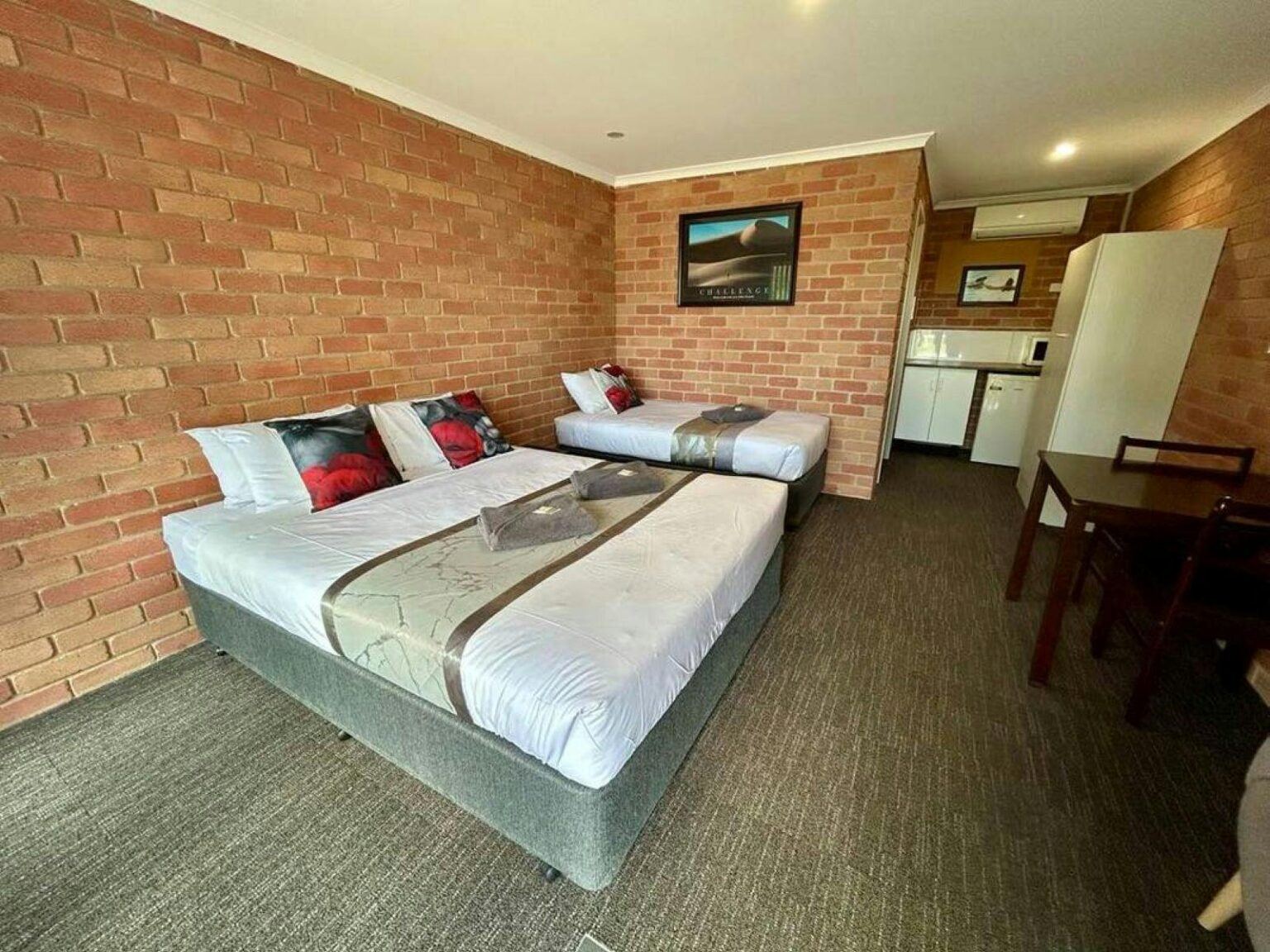 Queen bed with a kitchenette in view