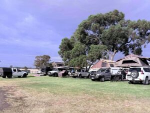 Line of vehicles with tents and caravans in a caravan park